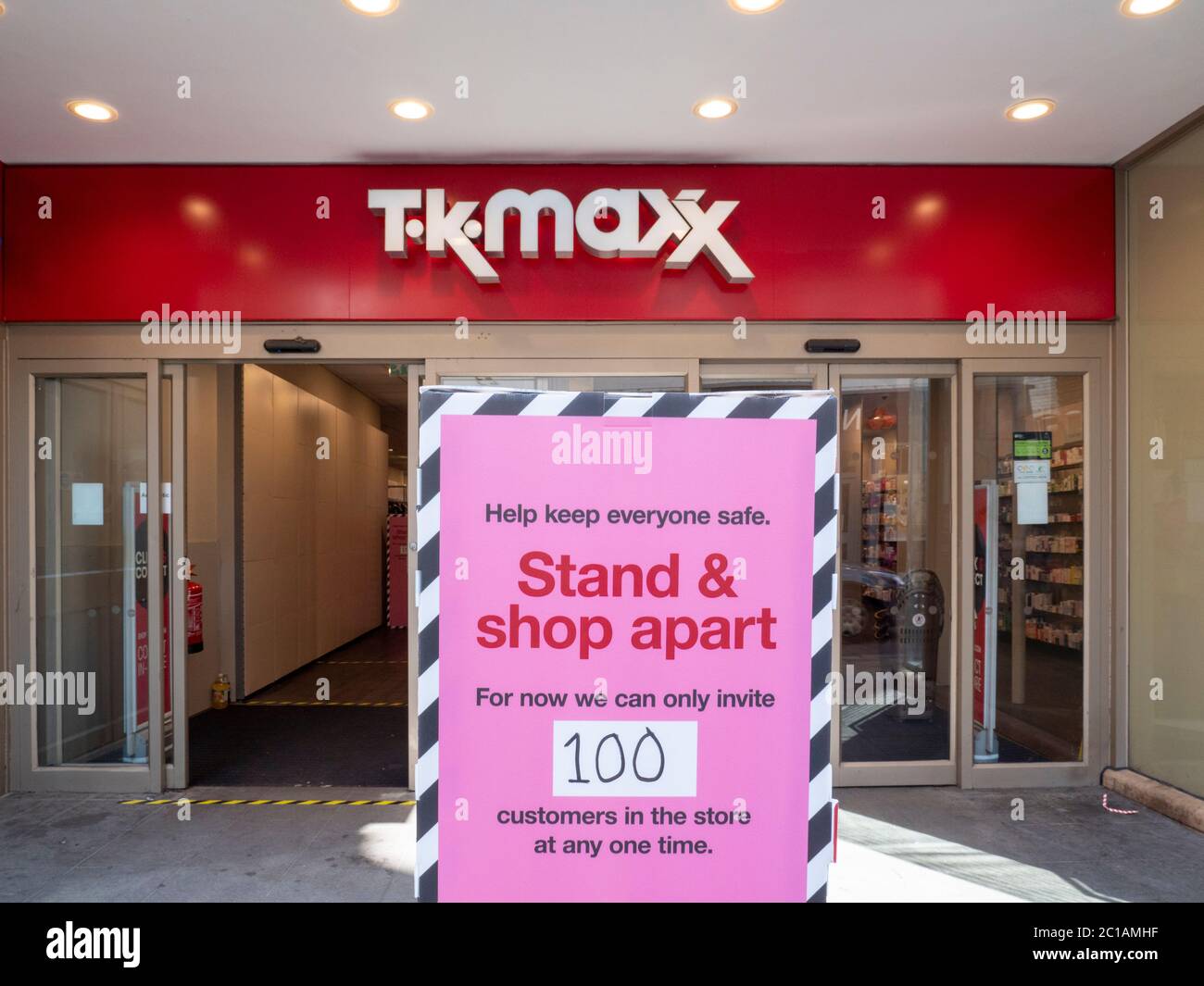 Cambridge, UK. 15th June, 2020. Social distancing signs outisde T K Maxx clothes shop as non essential retail shops open for the first time in three months after the coronavirus lockdown. Credit: Julian Eales/Alamy Live News Stock Photo