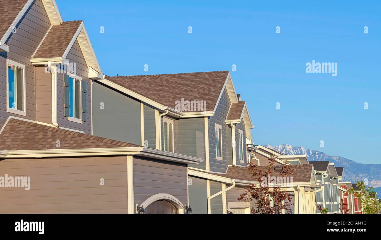 Panorama Row of houses in a suburb neighborhood with mountain and blue ...