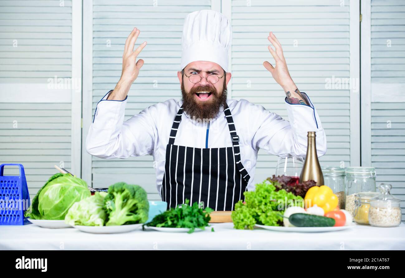 Chef at work starting shift. Guy in professional uniform ready cook. Master chef concept. Culinary challenge. Chef handsome hipster. Get ready. Man bearded chef getting ready cooking delicious dish. Stock Photo