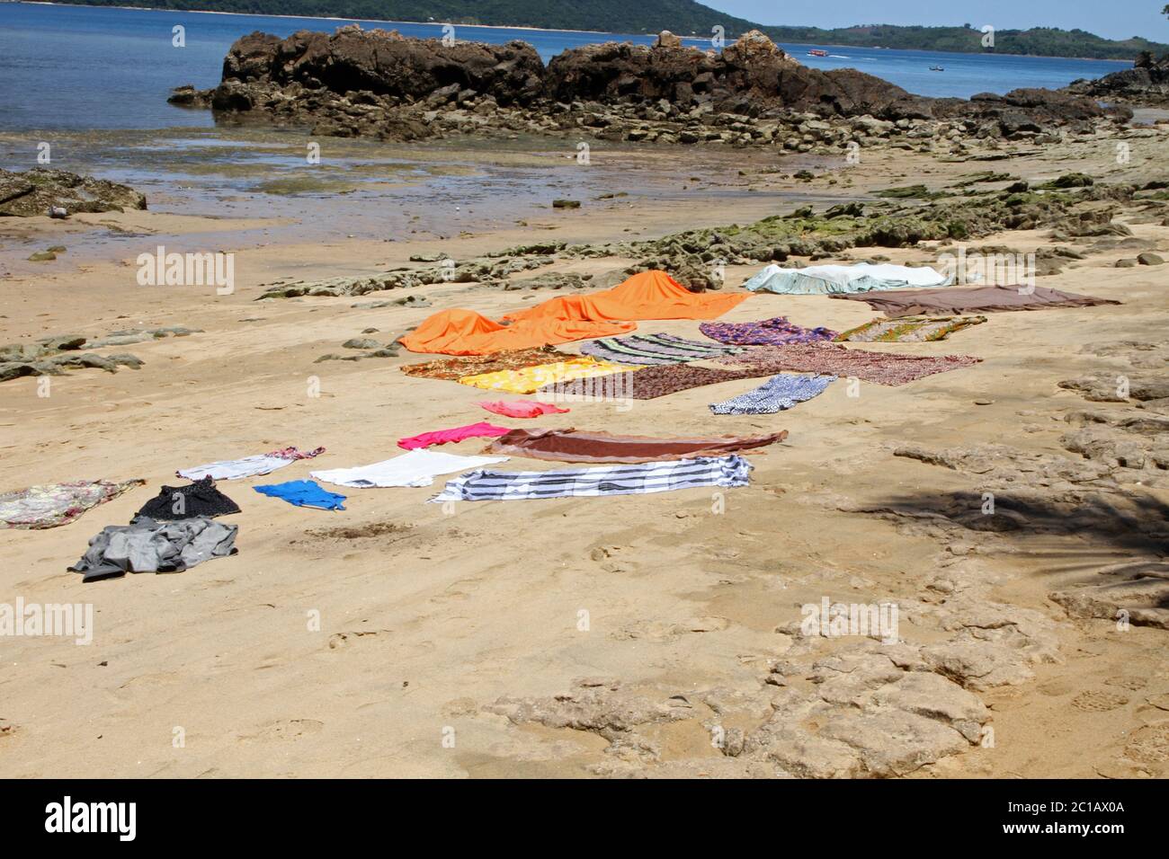 Clothing, blankets and linen drying on the beach floor, Ampangorinana Village, Nosy Komba Island
