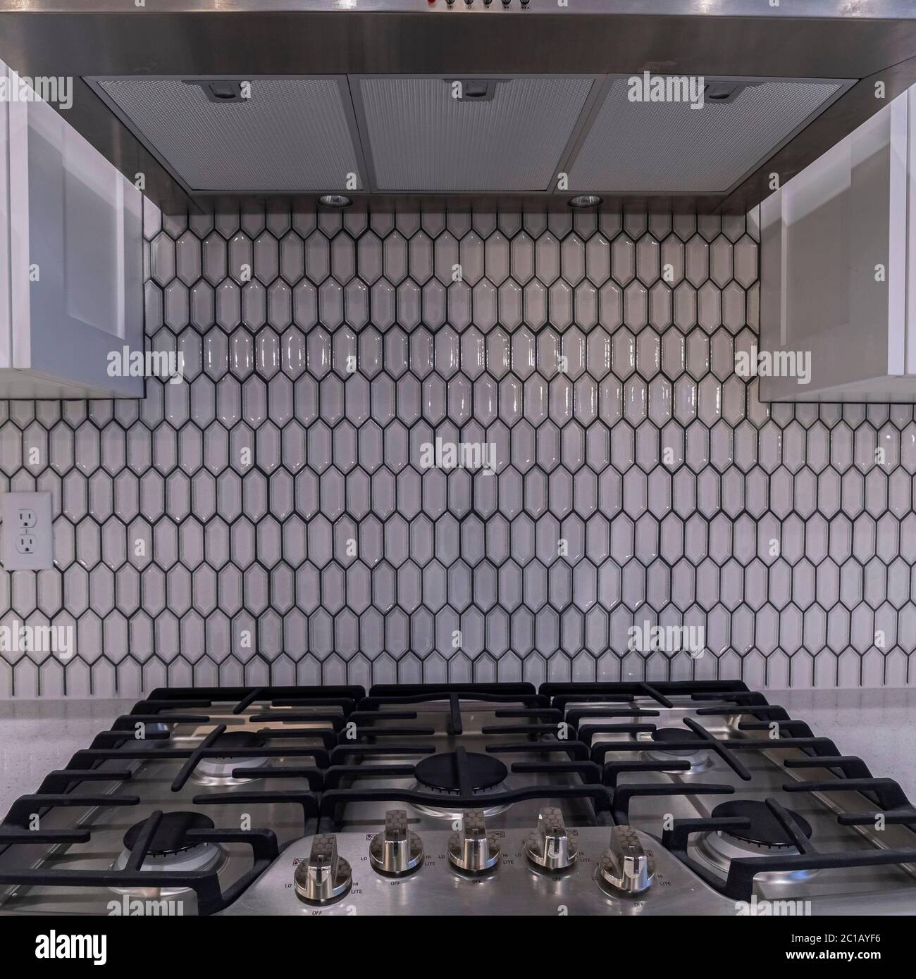 Square Modern gas cooker hob under an extractor fan Stock Photo Alamy