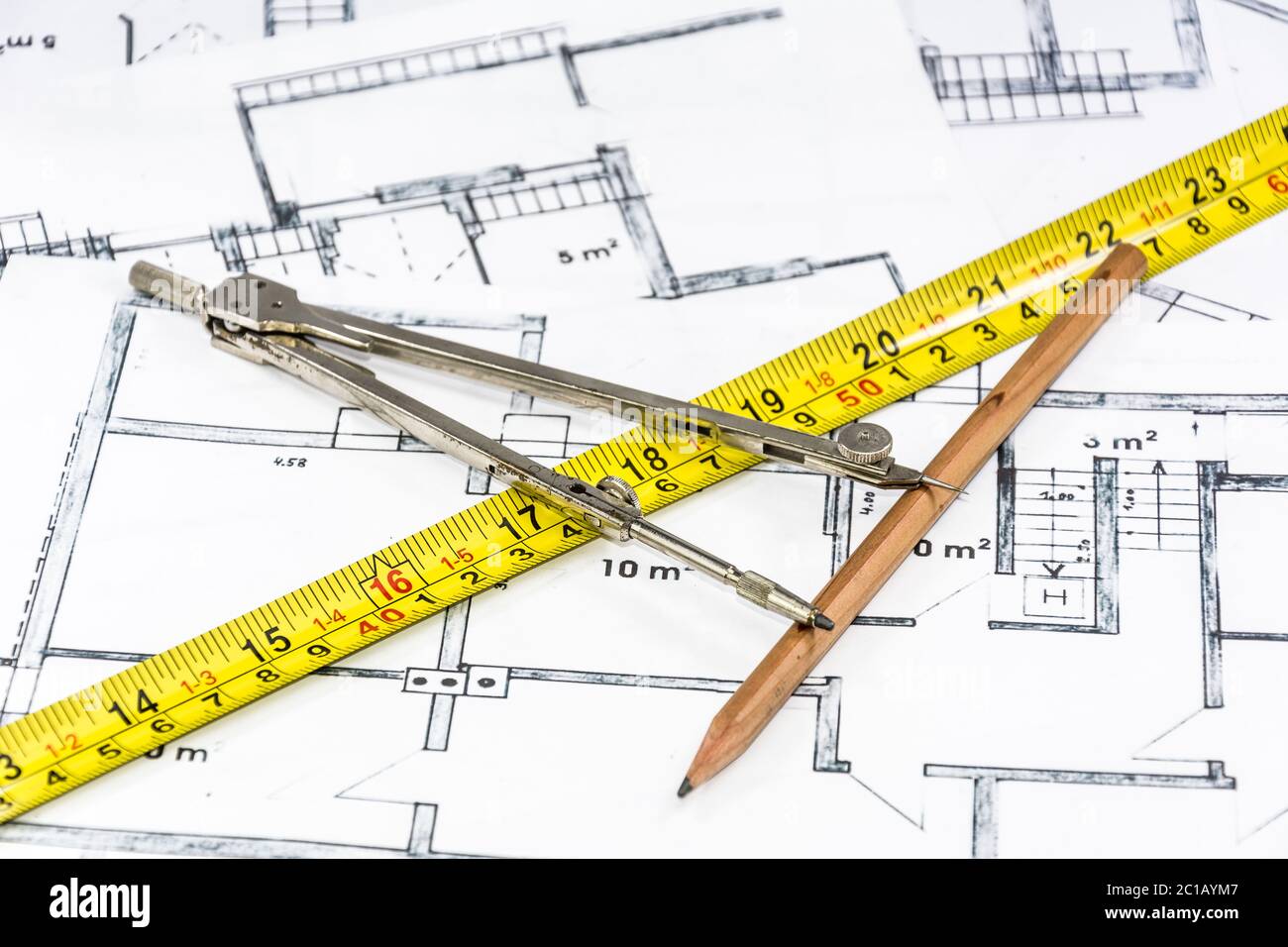 Compass calipers and pencil lying on construction plan Stock Photo