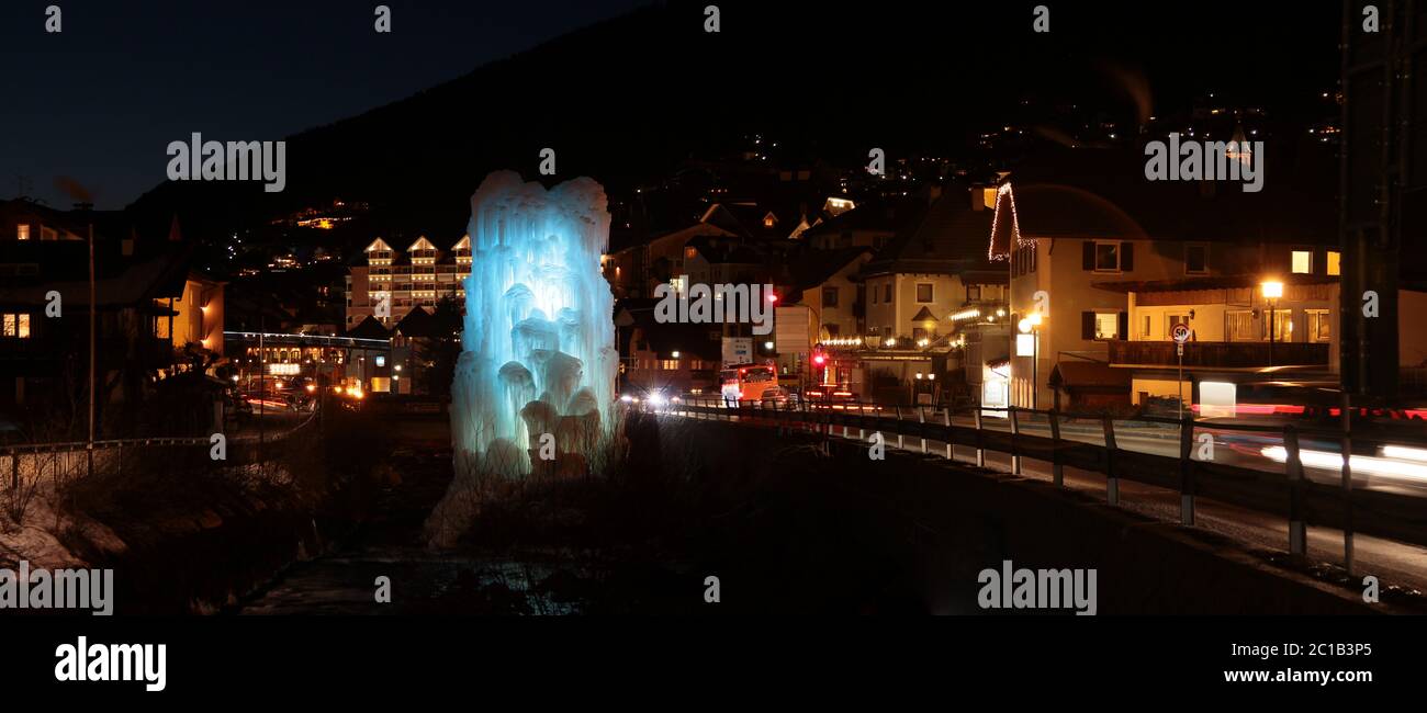 Panoramic night view of frozen fountains in Ortisei village. Dolomites. Tyrolean Alps. Trentino-Alto Adige. Italy. Stock Photo