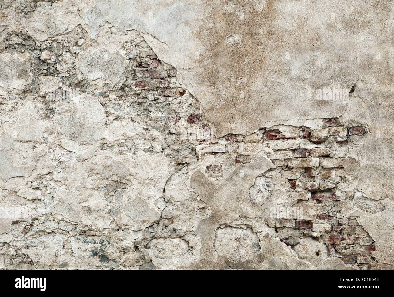 Old wall with brickwork under plaster Stock Photo