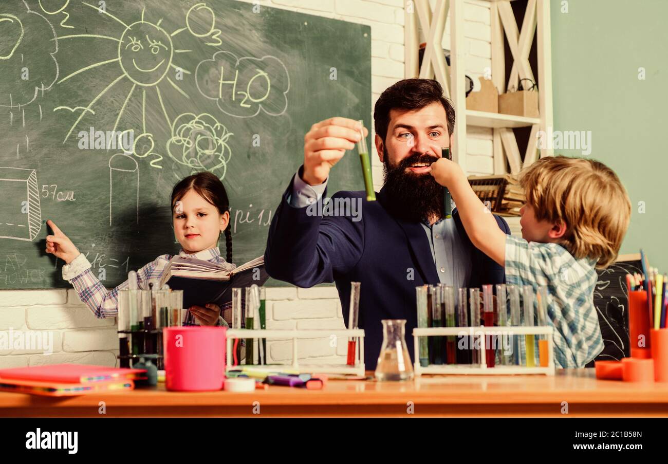 Teacher and pupils test tubes in classroom. School clubs interactive education. Clubs for preschoolers. After school clubs are great way to develop kids in different areas. Chemistry experiment. Stock Photo
