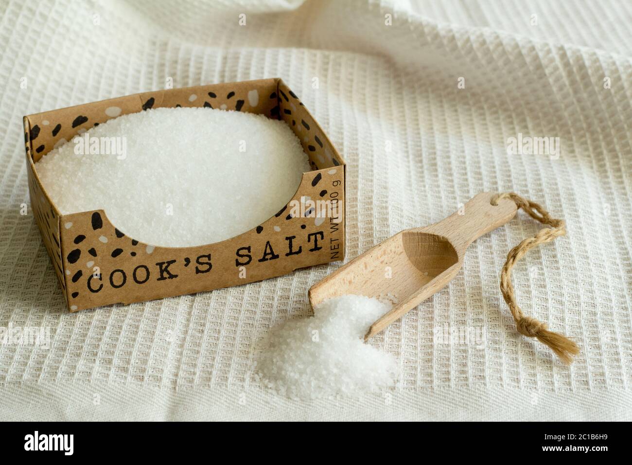 Chef's salt on white kitchen cloth with spoon Stock Photo