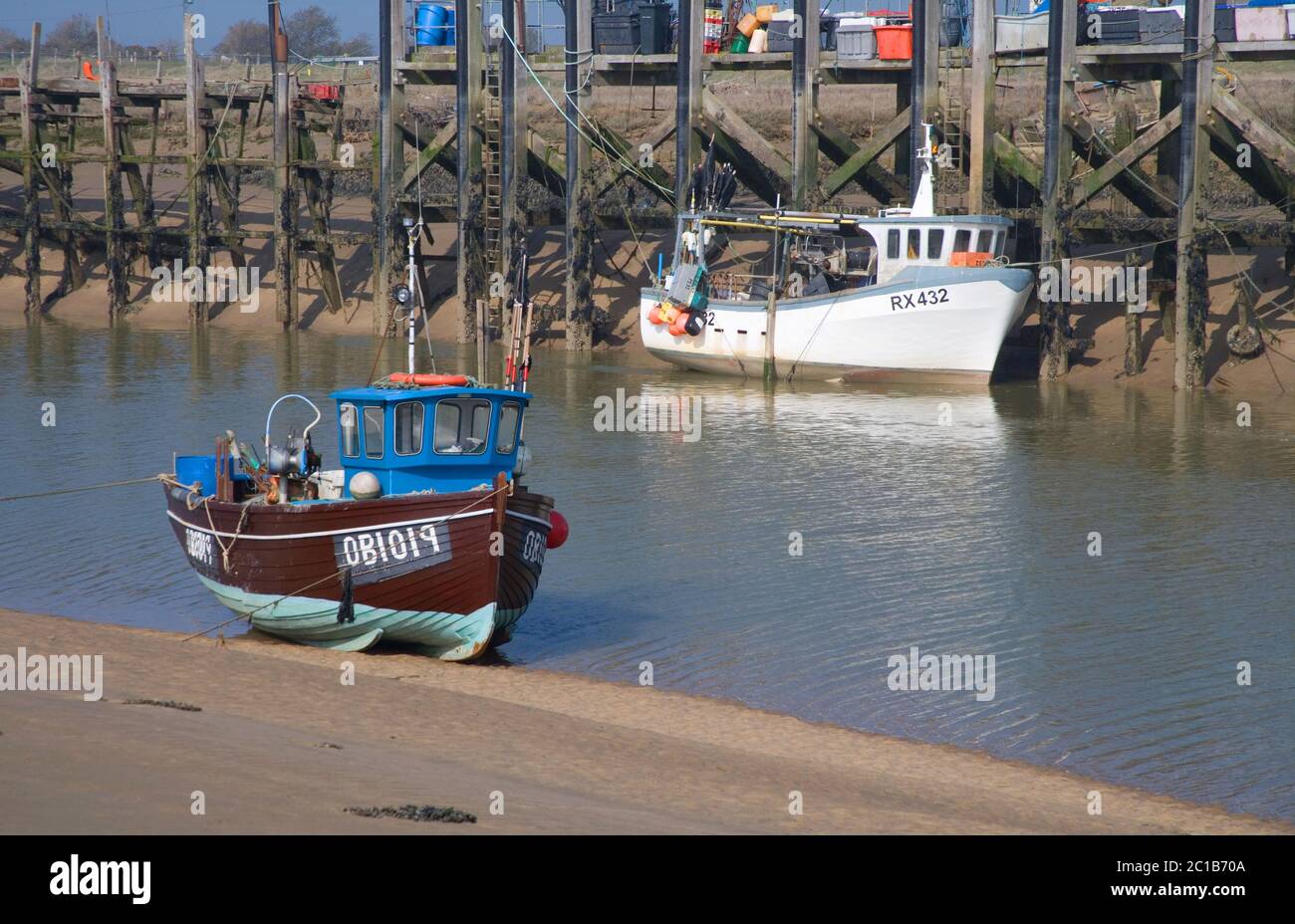 boats moored on the river rother at rye harbour entrance on the east sussex coast Stock Photo