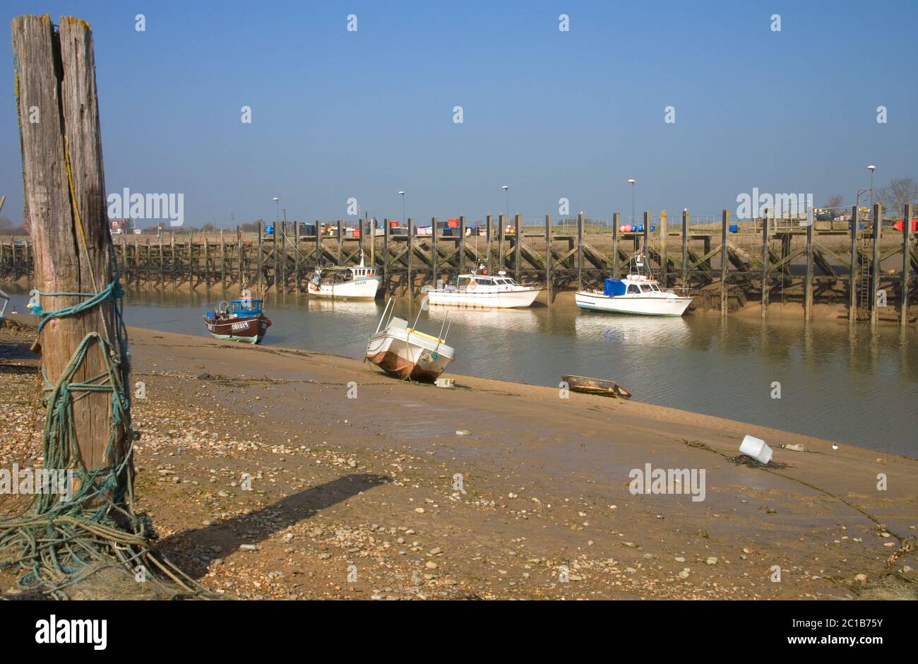 boats moored at low tide rye harbour entrance on the east sussex coast