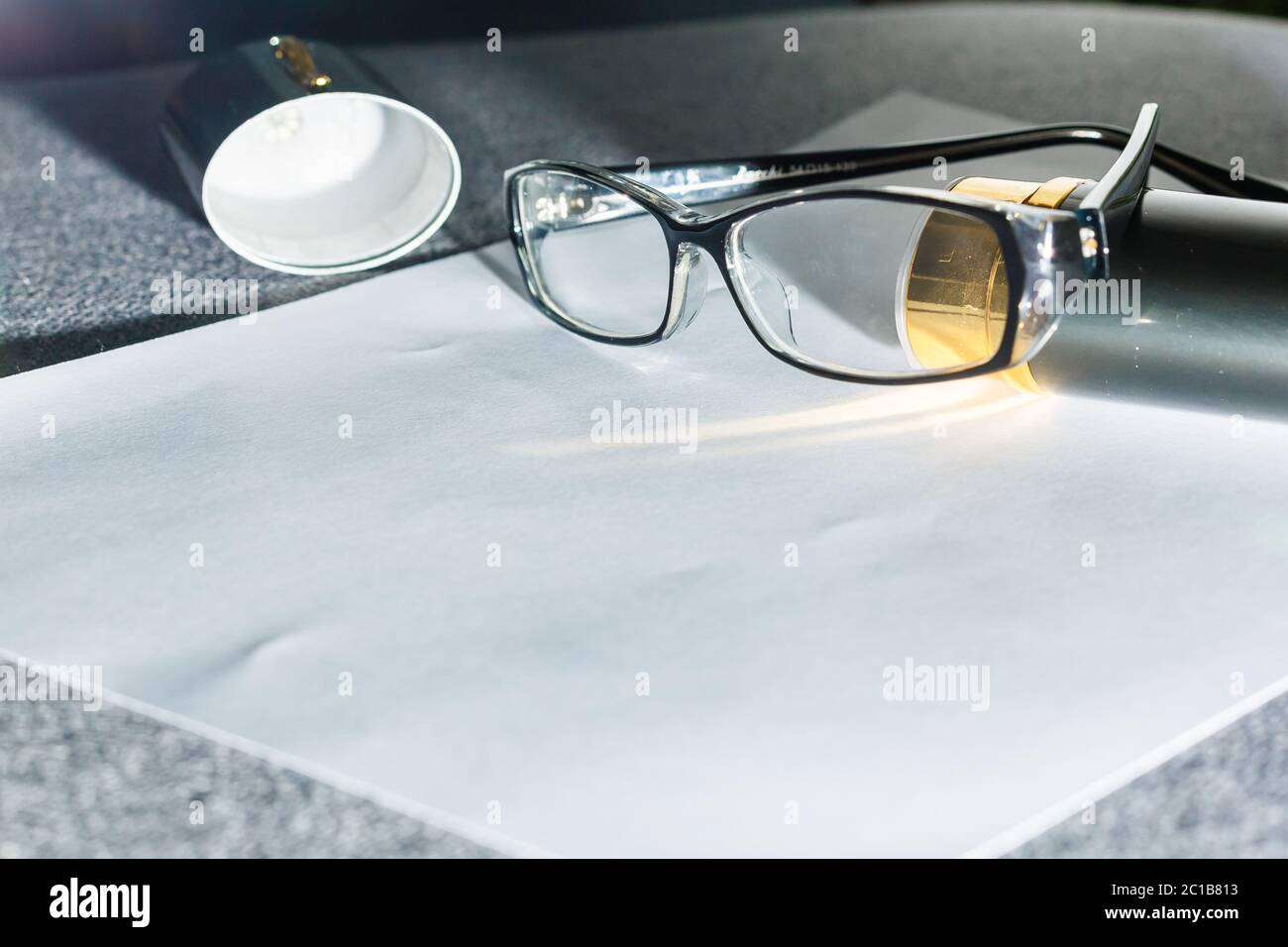 Magnifier, glasses and notebook paper Stock Photo Alamy