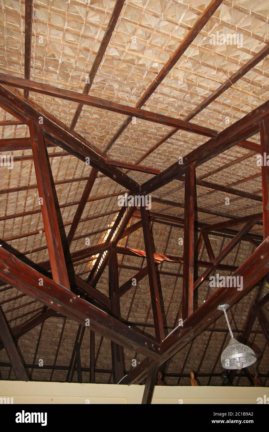 Traditional palm-leaved thatch roof ceiling with wooden beams ...