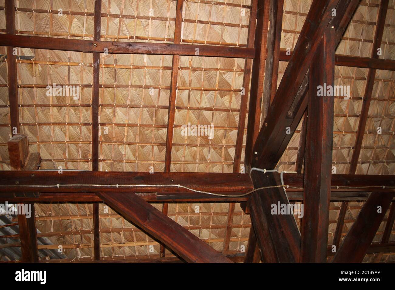 Traditional palm-leaved thatch roof ceiling with wooden beams ...