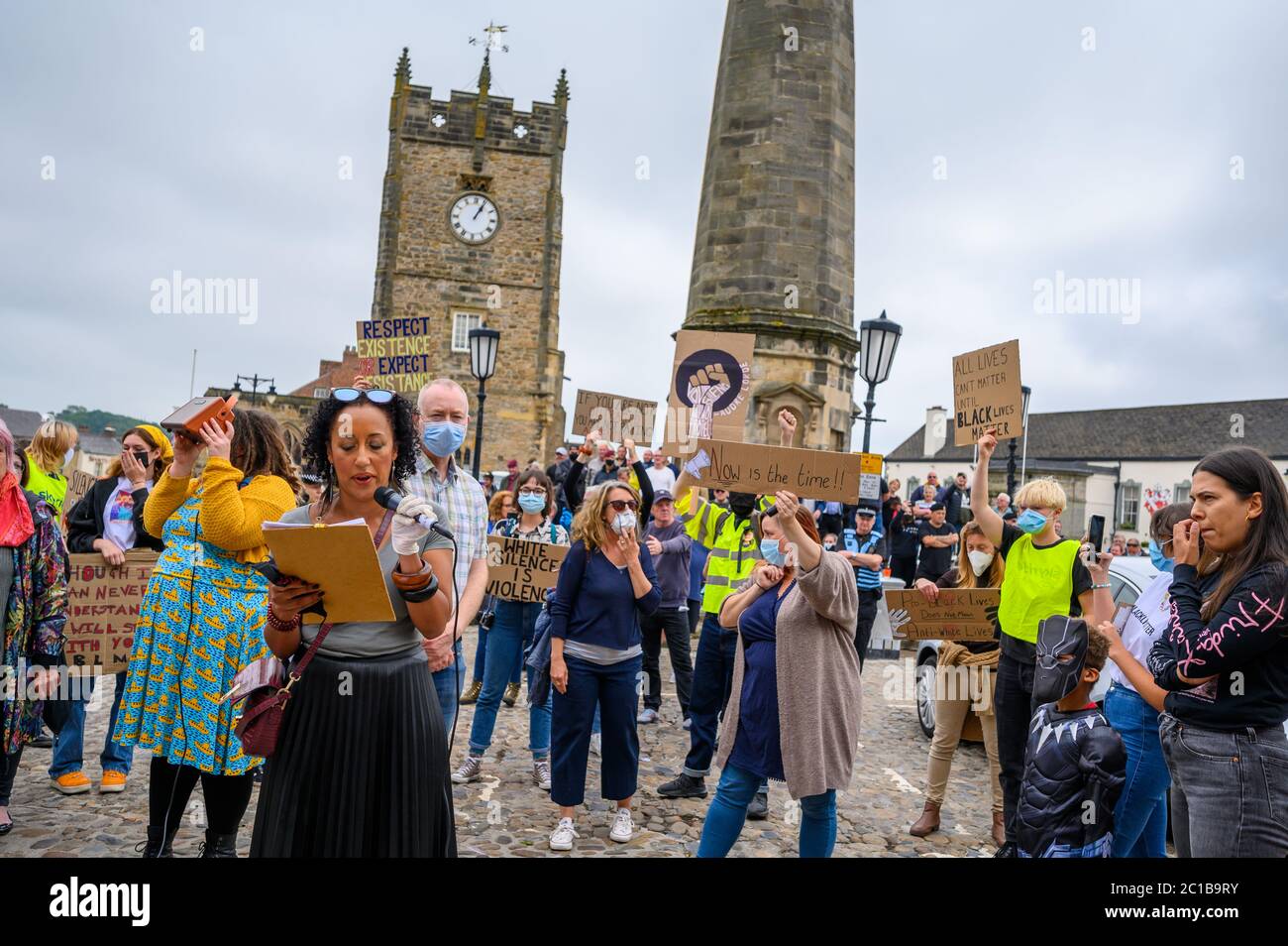 Richmond, North Yorkshire, UK - June 14, 2020: BLM protester speaking in front of The Obelisk and The Green Howards Museum at a Black Lives Matter pro Stock Photo
