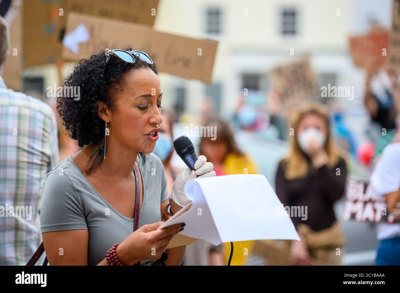 Richmond, North Yorkshire, UK - June 14, 2020: A female speaker at a Black Lives Matter protest in Richmond, North Yorkshire with other protesters out Stock Photo