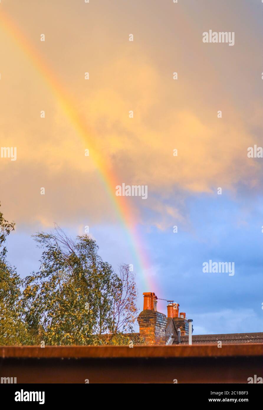 Colorful Rainbow overlooking balcony with blue cloudy sky in London, UK Stock Photo
