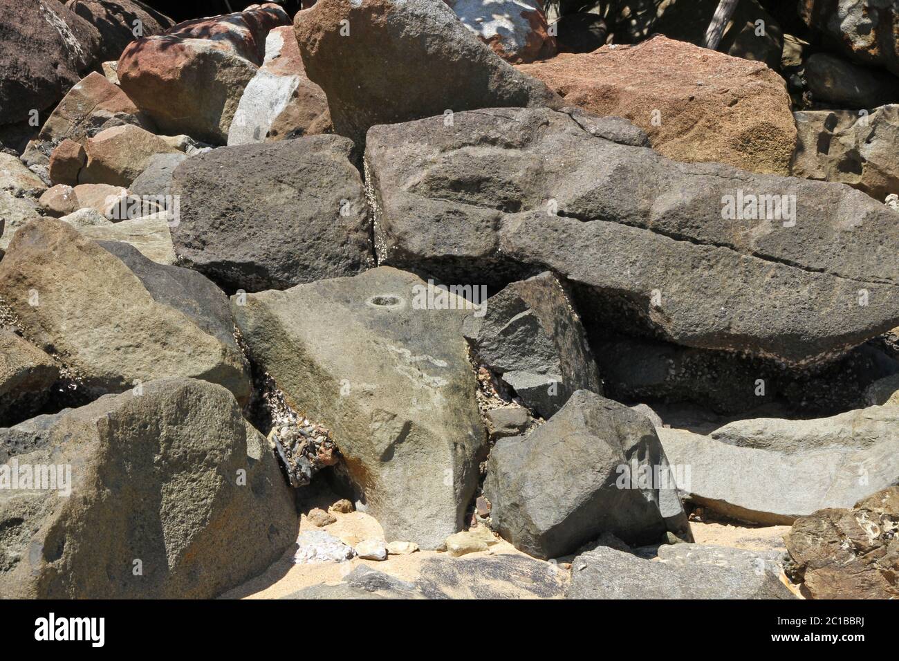 Rocks on beach, Ampangorinana Village, Nosy Komba Island, Madagascar. Stock Photo