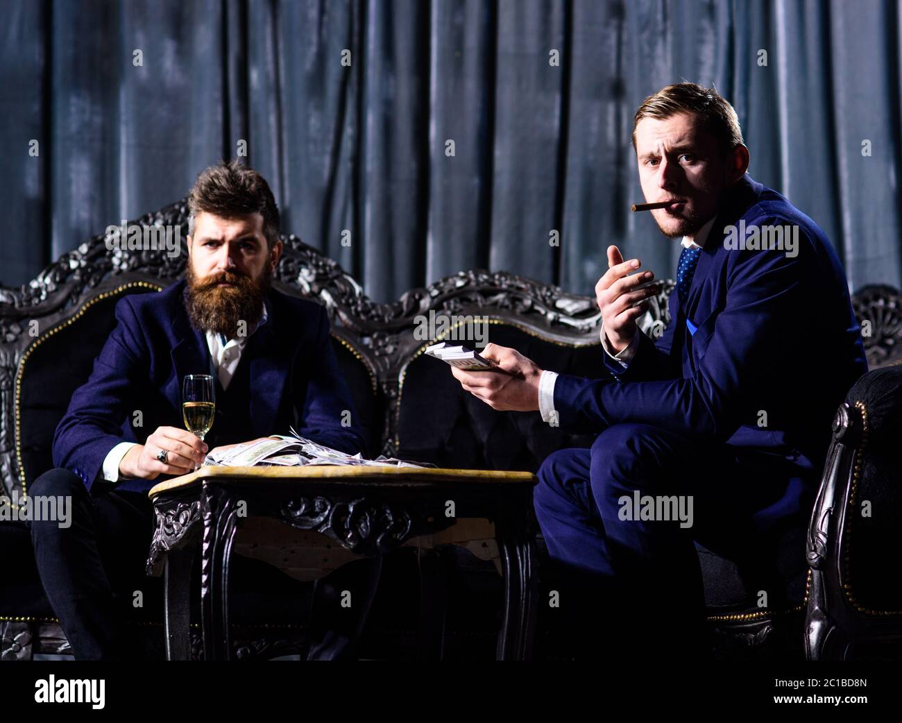 Mafia, gangsters, profit concept. Criminals with cash. Friends sit on