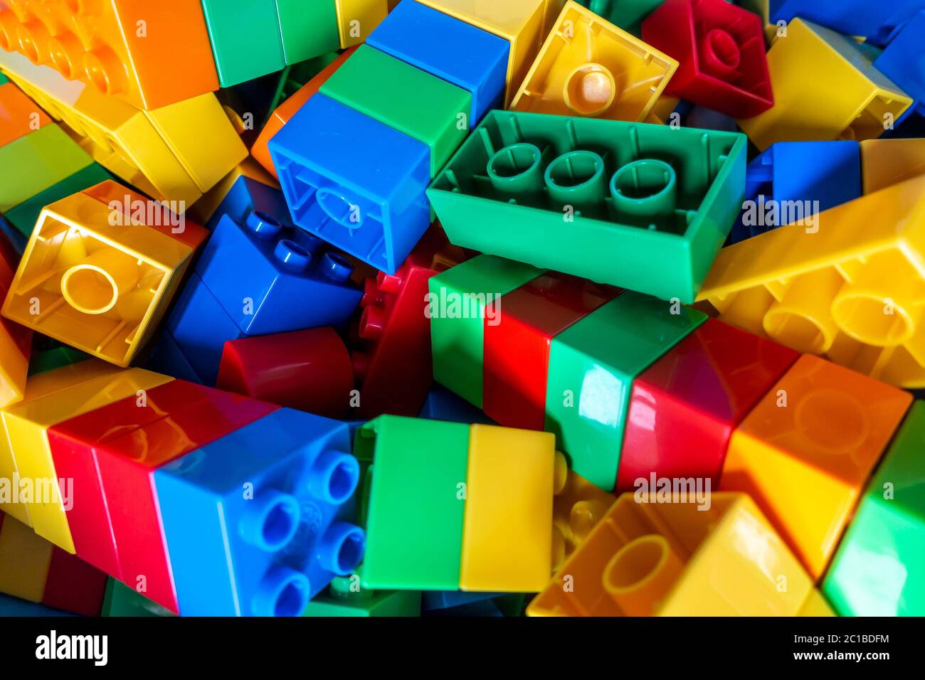 Colourful plastic building block toy set as used by a young child which promotes problem solving and creativity, Stock Photo