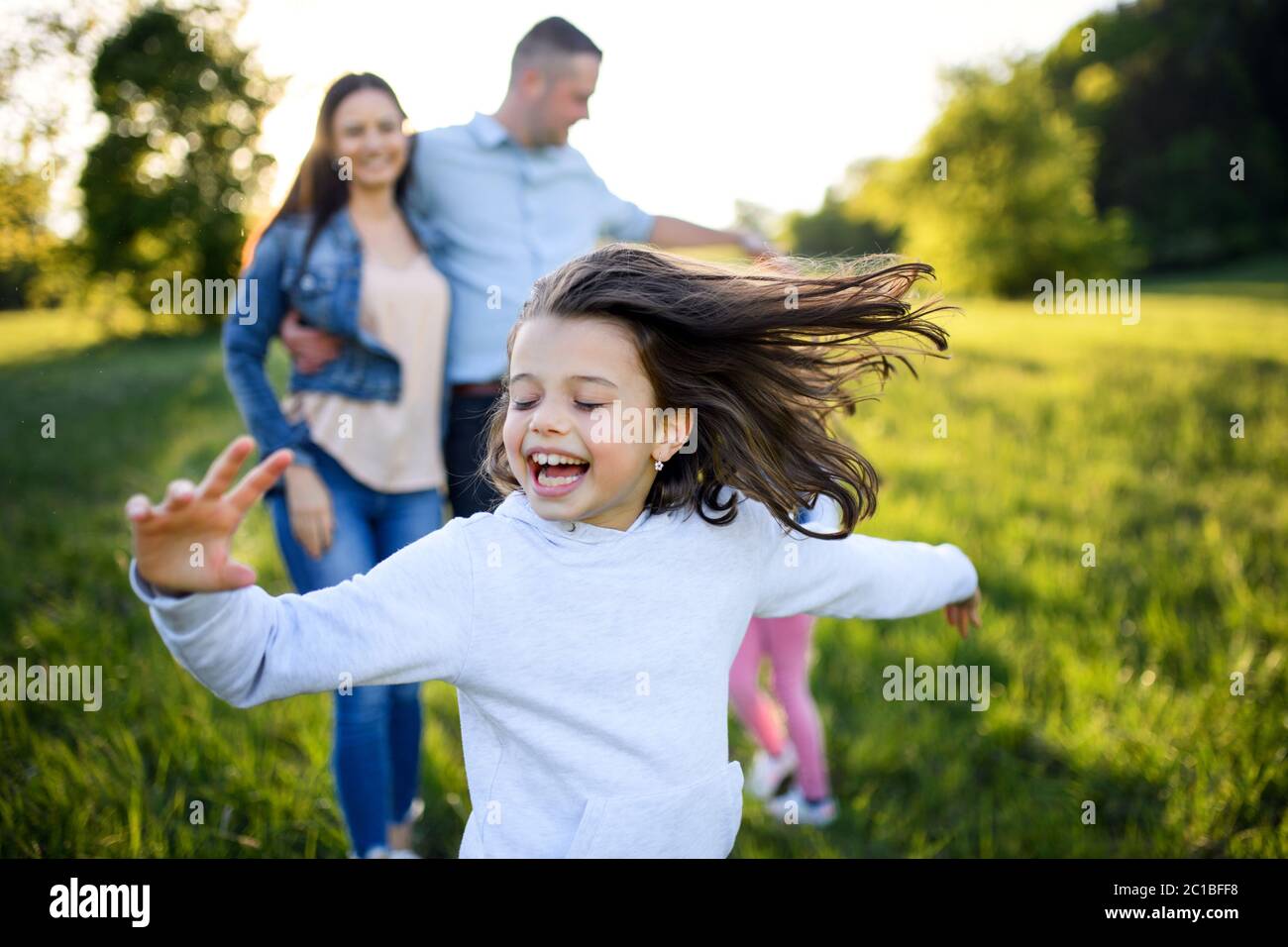 Happy family with two small daughters having fun outdoors in spring nature  Stock Photo - Alamy