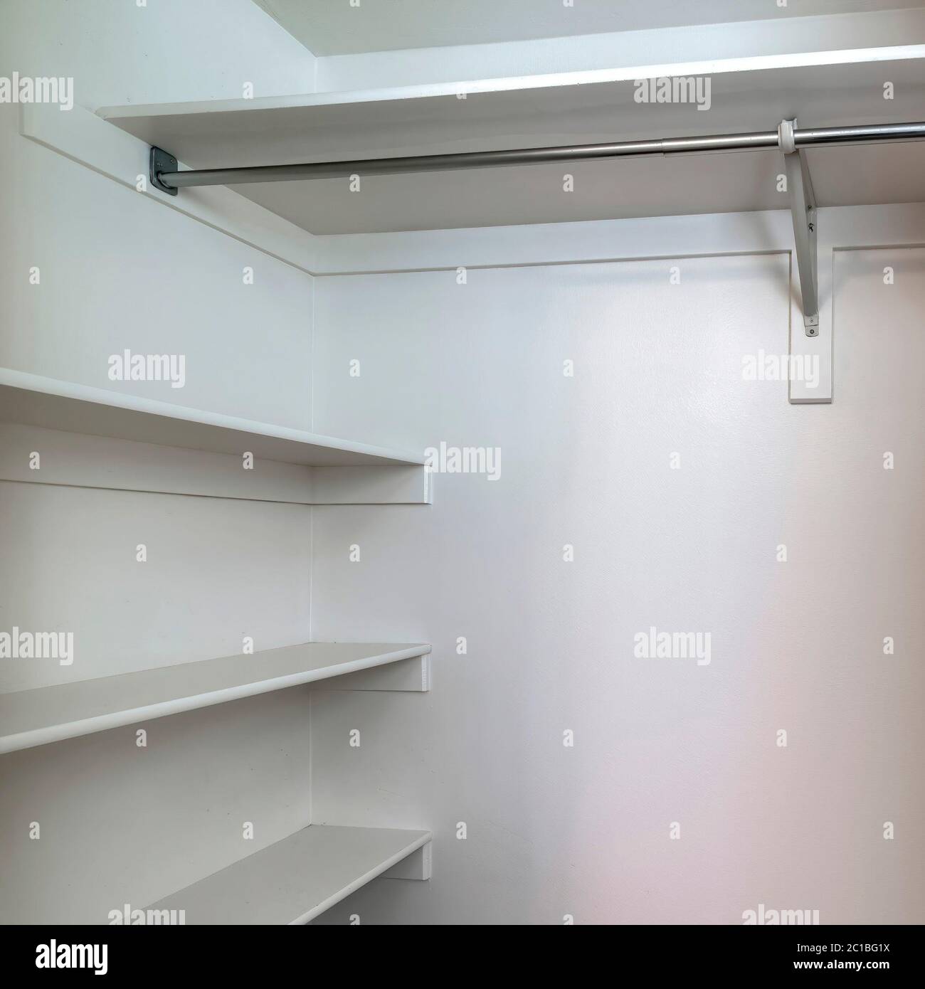 Square frame Empty walk in closet of new home with wall shelves and ...