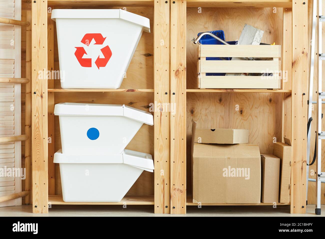 Image of wooden shelves with trash bins and boxes with instruments for