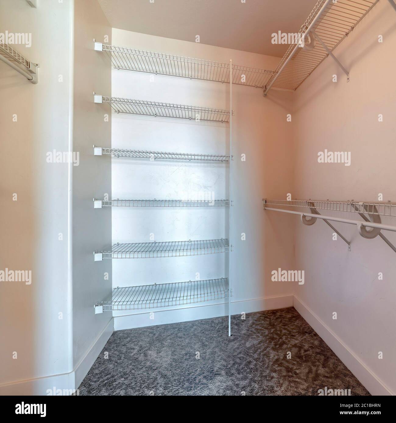 Square Walk in closet with metal racks and hanging rods mounted on
