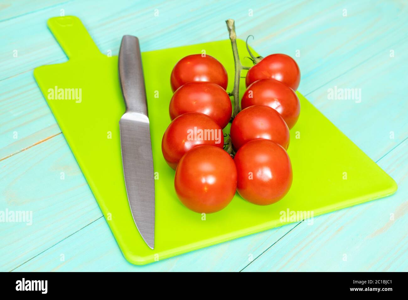 Cherry tomatoes and knife Stock Photo - Alamy