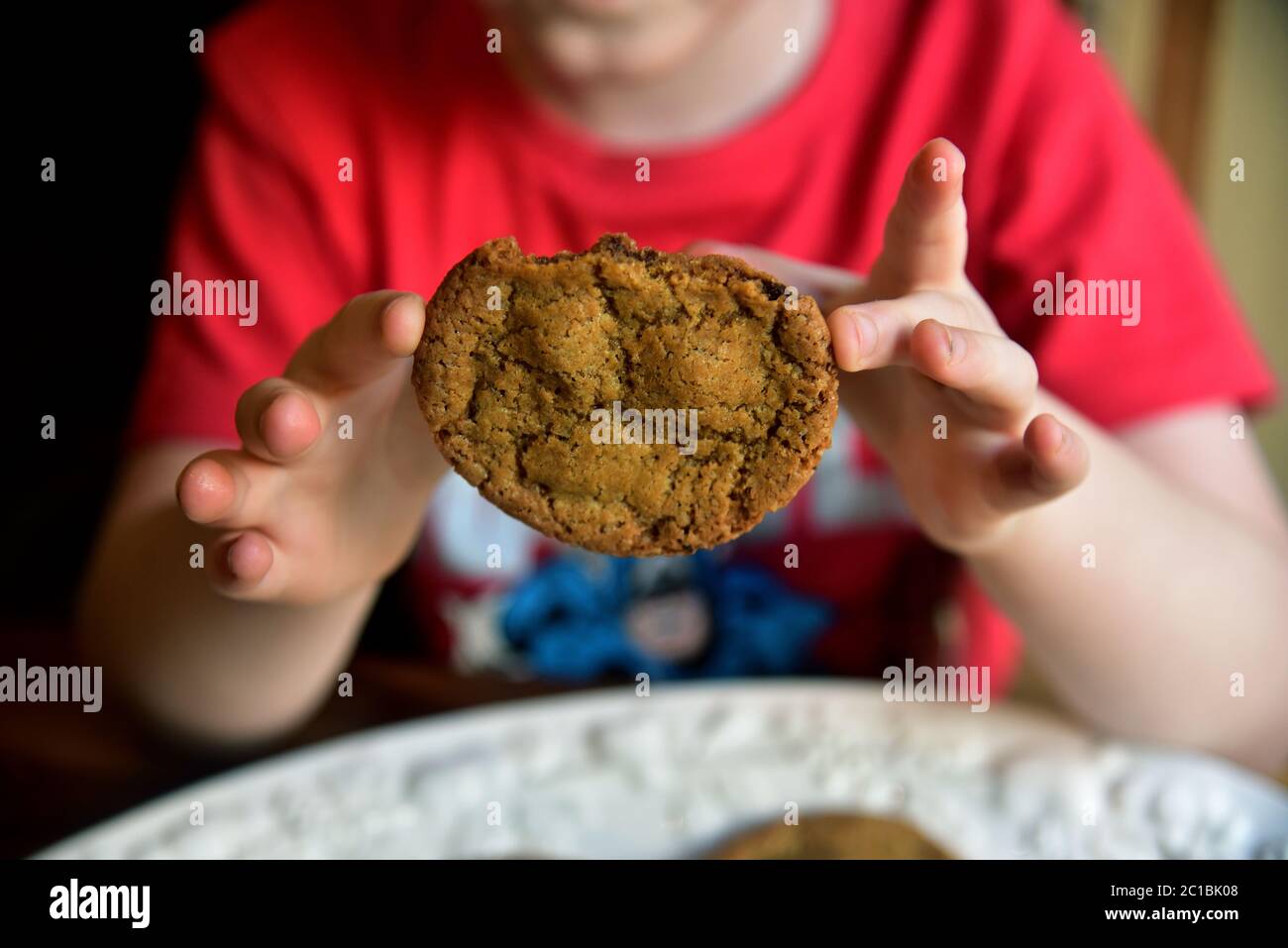 A primary school pupil is pictured baking chocolate chip cookies as part of his home schooling in lockdown during the Covid-19 pandemic Stock Photo