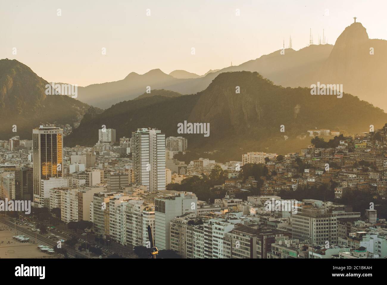 Sunset View in Copacabana, Apartment Buildings, Favela Babilonia, Mountains, and Corcovado With Christ Statue, in Rio de Janeiro, Brazil Stock Photo