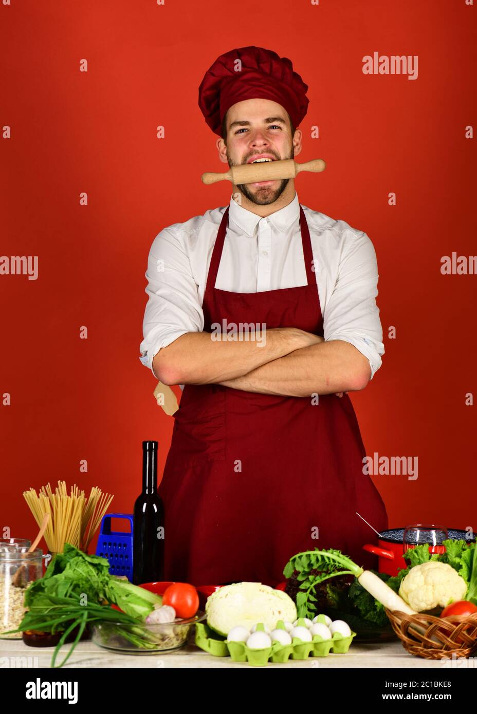 Man in cook hat and apron gets ready to cook. Cook works in 