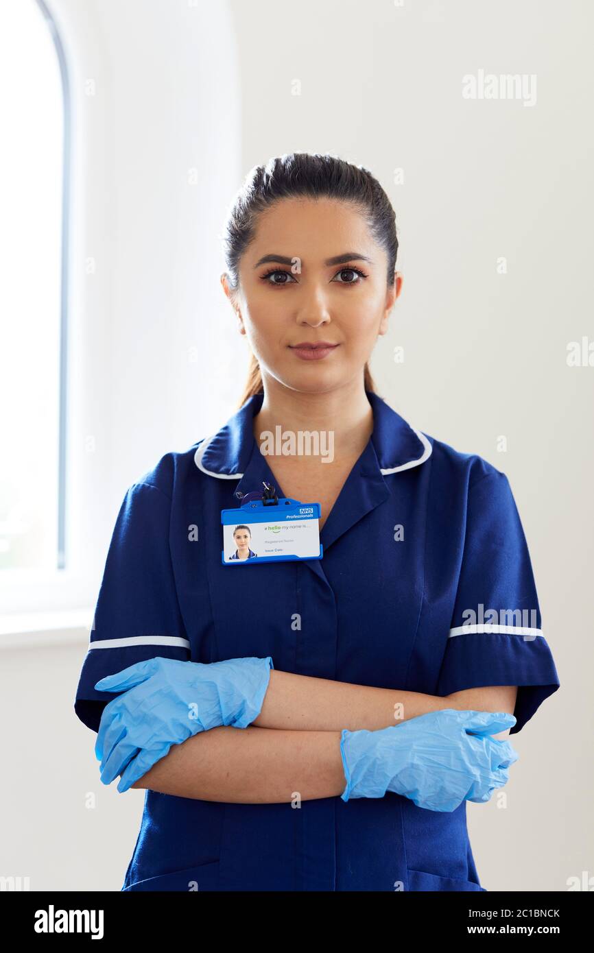 Portrait of nurse wearing stretch vinyl gloves Stock Photo