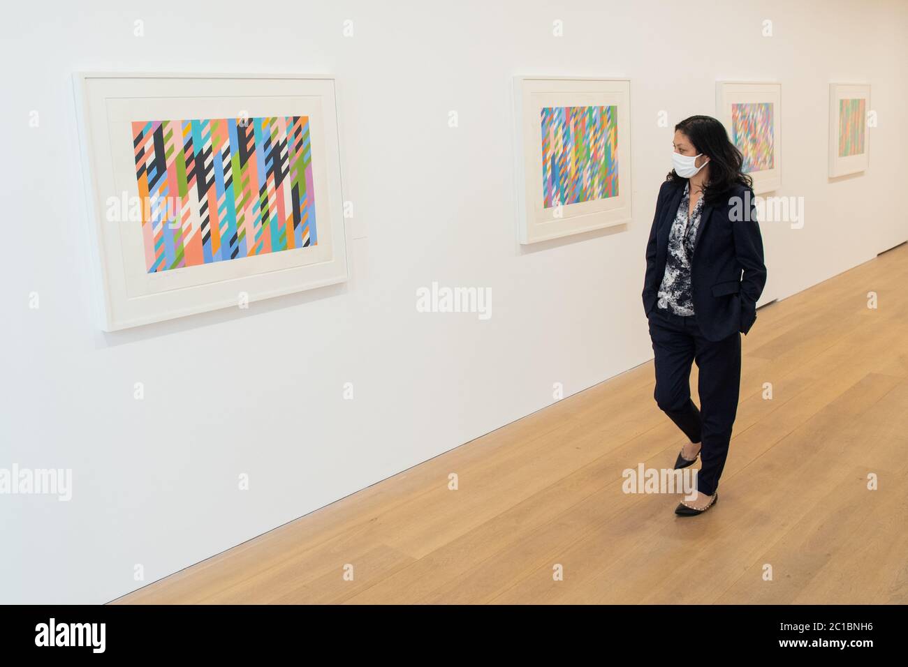 Angela Choon views artworks by Bridget Riley at the David Zwirner modern art gallery in Mayfair, London as non-essential shops in England open their doors to customers for the first time since coronavirus lockdown restrictions were imposed in March. Stock Photo