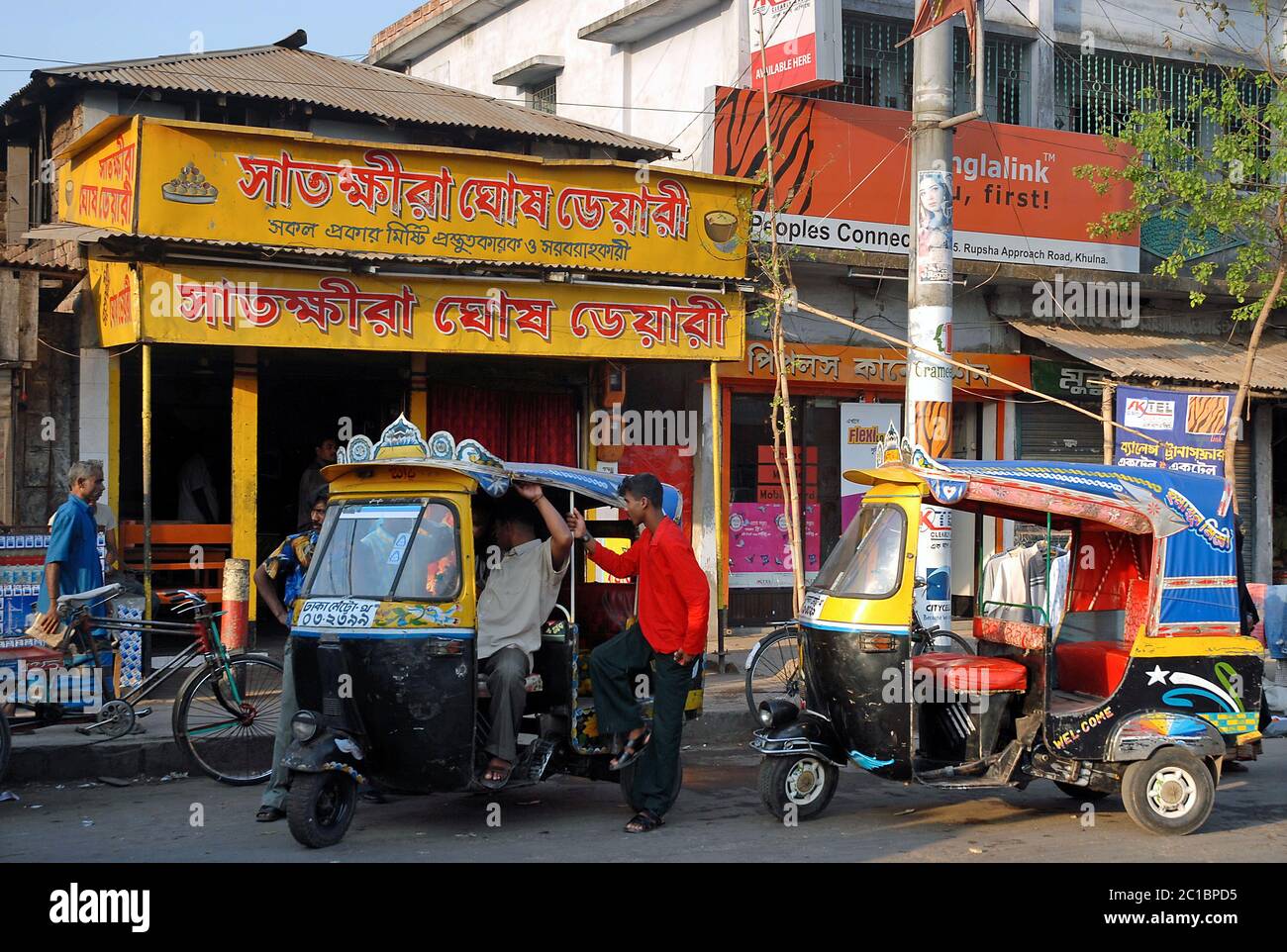 Khulna in Bangladesh. Two auto rickshaws with drivers waiting for