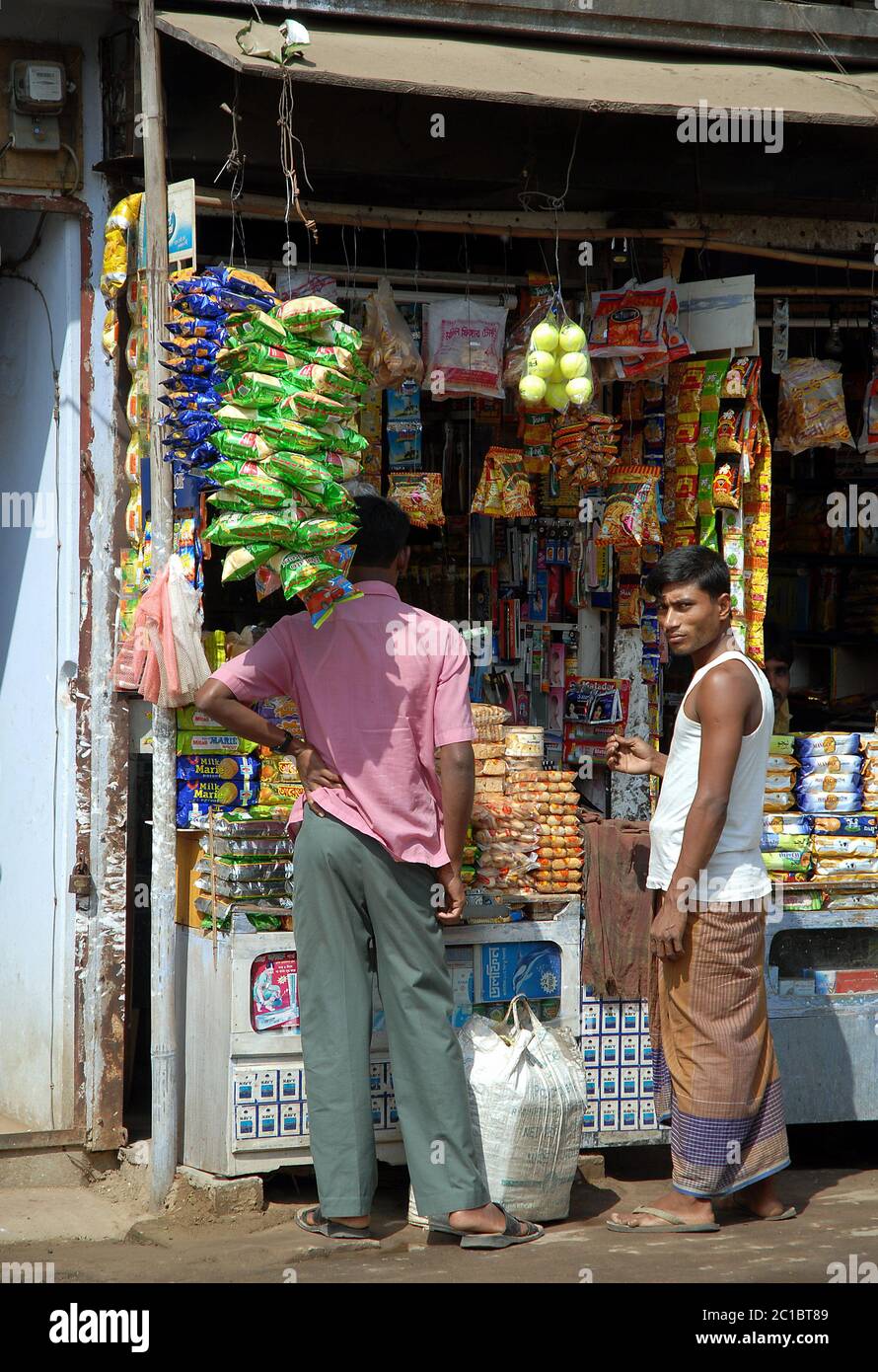 Srimangal (Sreemangal) in Sylhet Division, Bangladesh. Two men at a small store in Srimangal (Sreemangal). This local shop sells everyday items. Stock Photo
