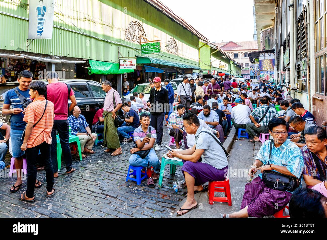 Local Men Sitting Down At A Cafe In Bogyoke Aung San Market, Yangon, Myanmar. Stock Photo