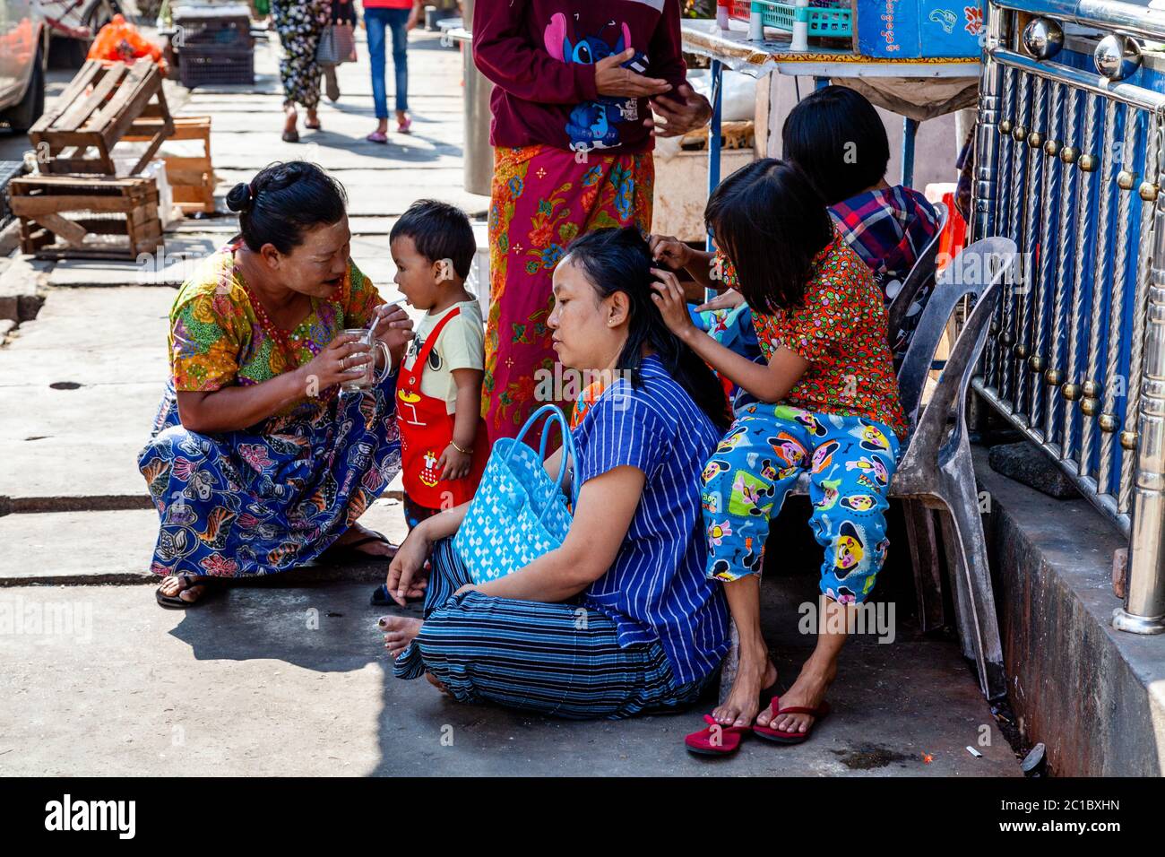 Burmese Families Sitting In The Street, Yangon, Myanmar Stock Photo