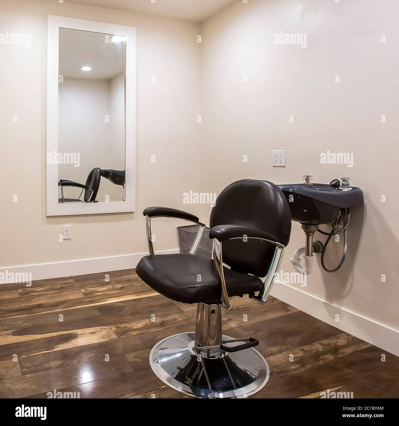 Square frame Hairdresser chair and backwash shampoo bowl inside salon with  bench and mirror Stock Photo - Alamy