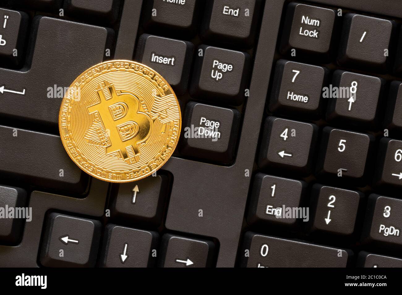 Bitcoin on black computer keyboard Stock Photo