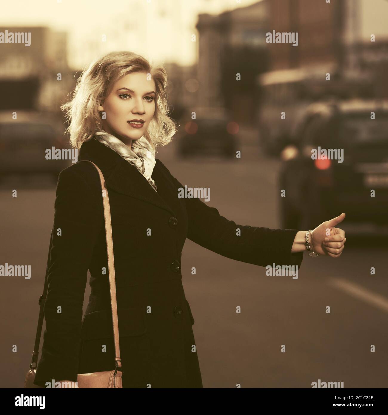 Businesswoman hailing a taxi cab hi-res stock photography and images ...