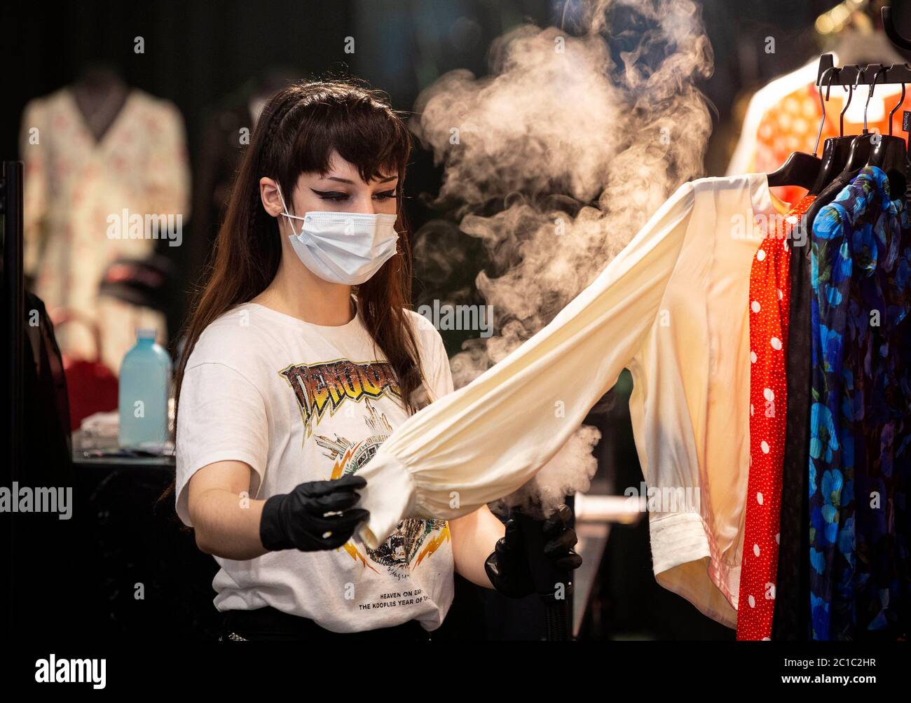 EDITORIAL USE ONLY Julia Teran, from The Kooples shop in Chelsea, steams clothes today as the area sees more than three quarters of its shops re-open after months of management planning. Stock Photo