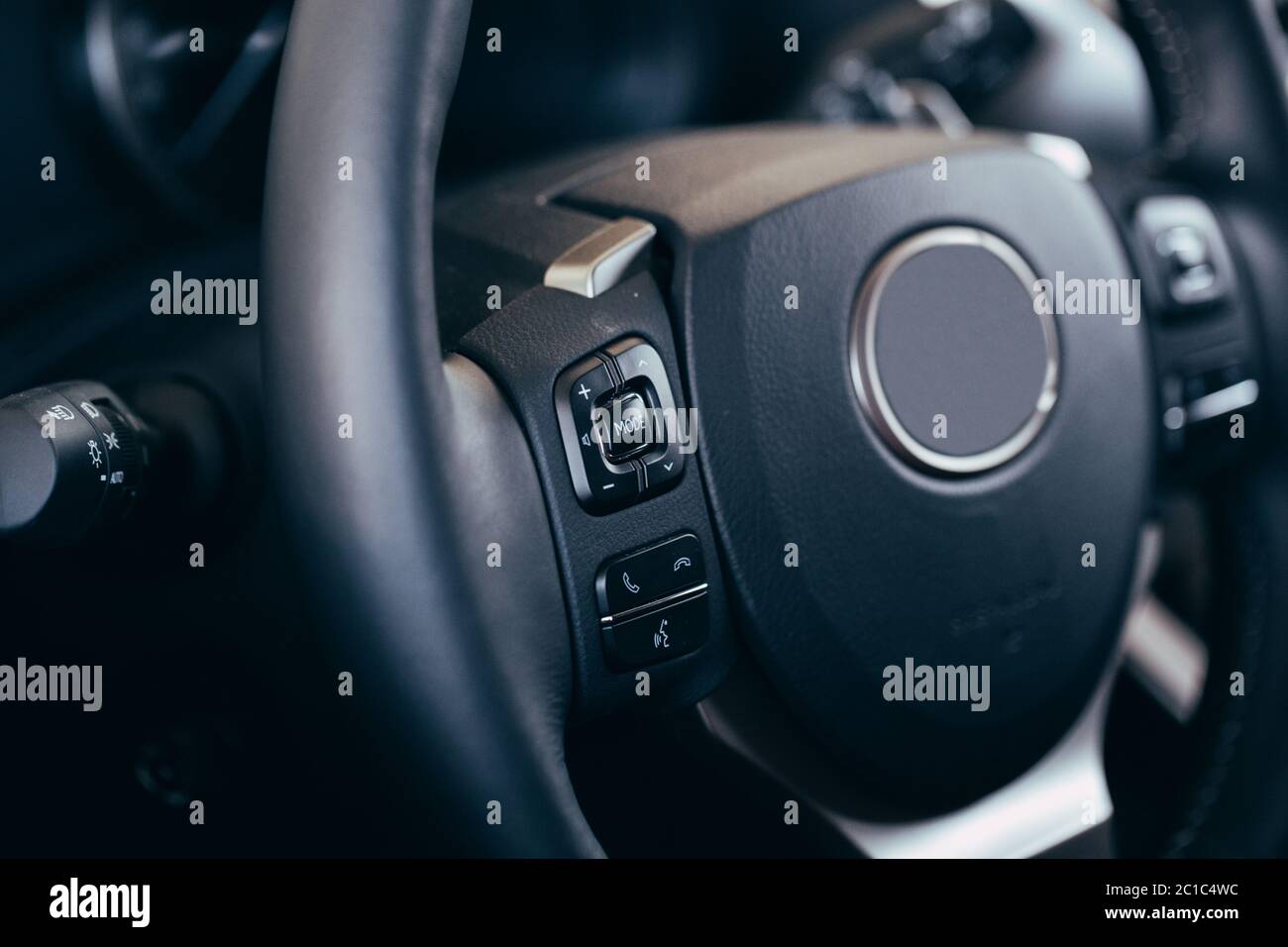 close up Modern black steering wheel with multifunction buttons