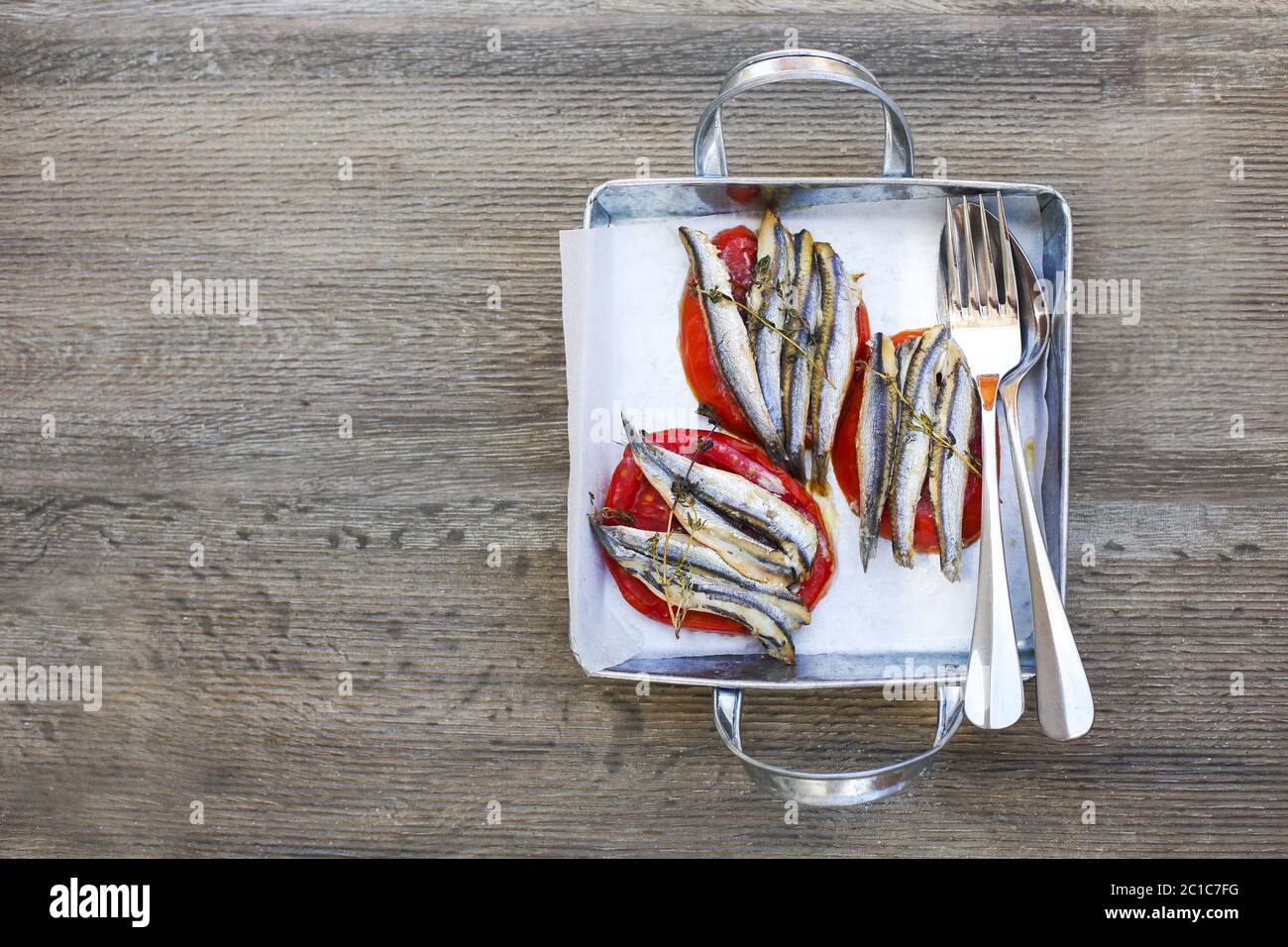 Grilled sardines and tomato on silver metal pan Stock Photo