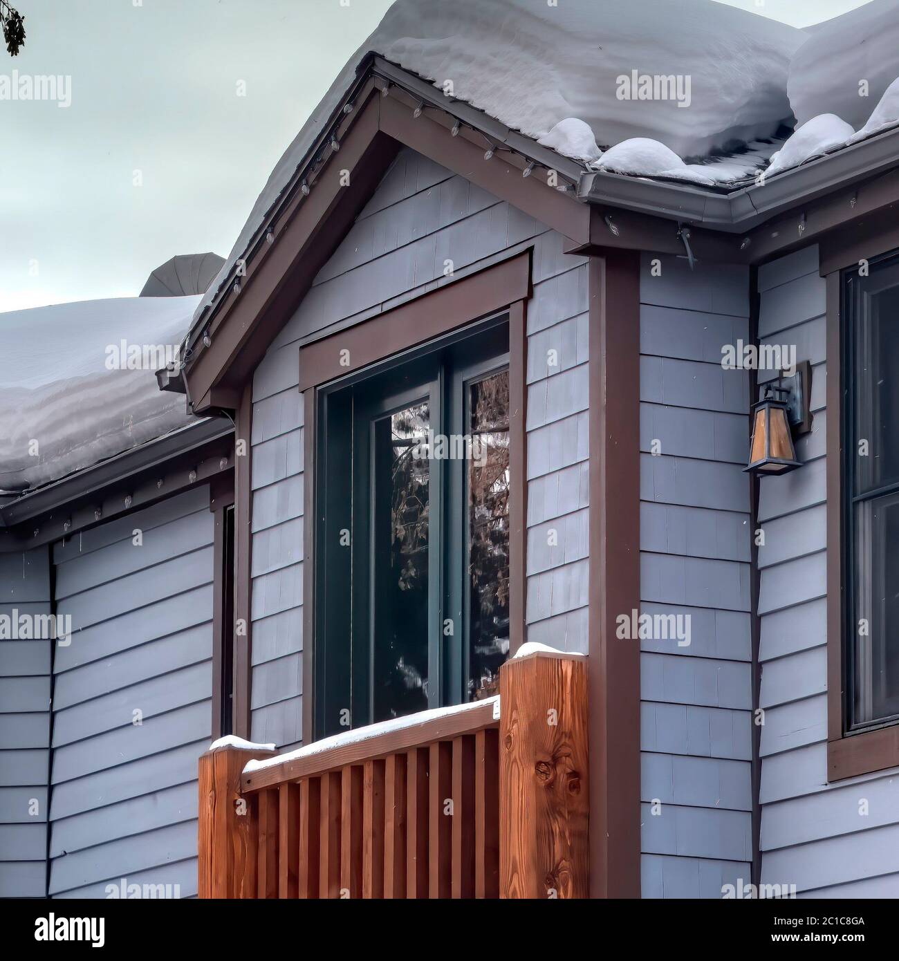 Square Box bay window of home with gable roof sliding door and wooden railing Stock Photo Alamy