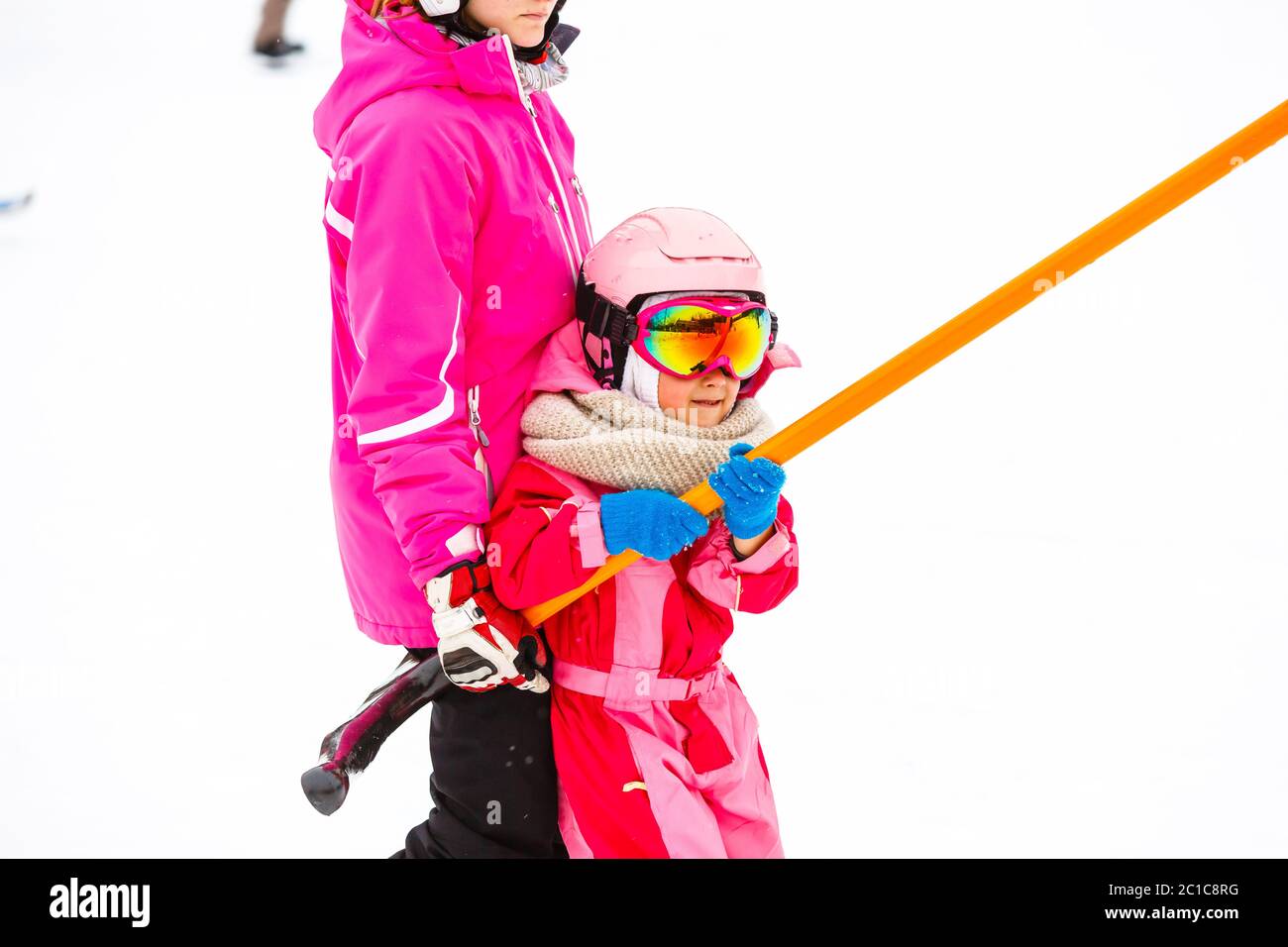 Ski lesson, little girl skiing with an instructor Stock Photo Alamy