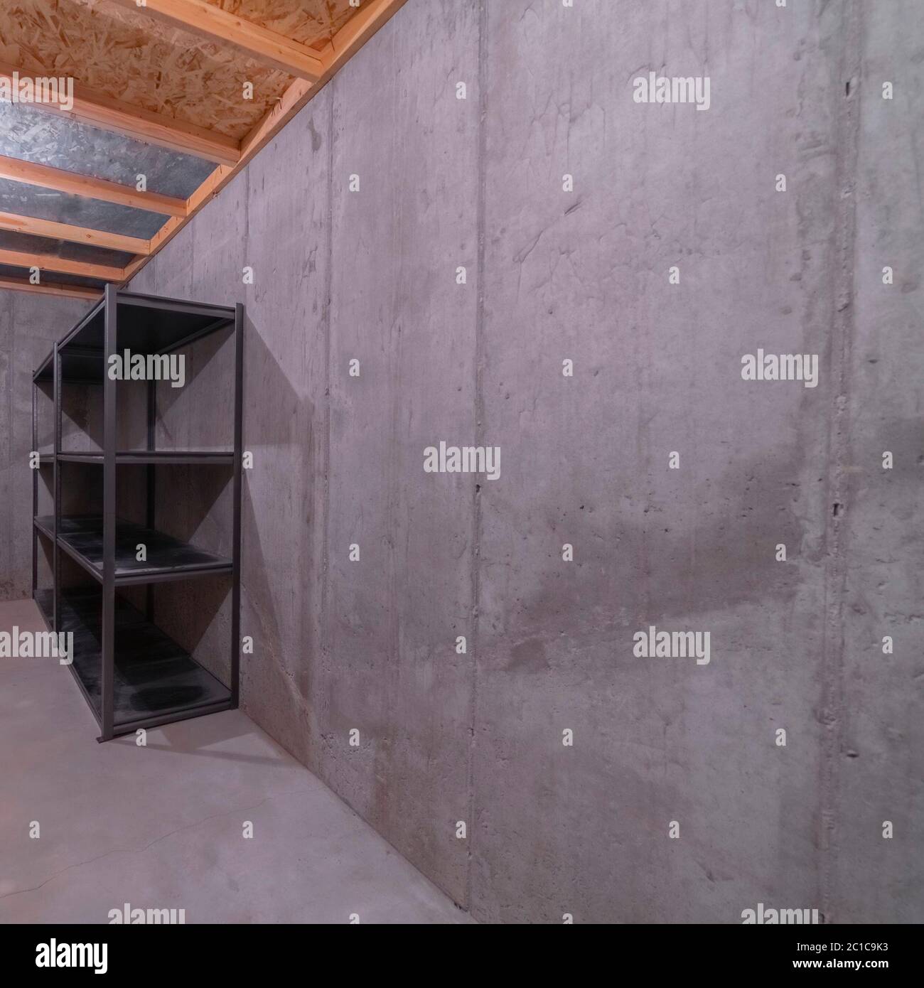 Square Storage shelves in a bare concrete room Stock Photo - Alamy