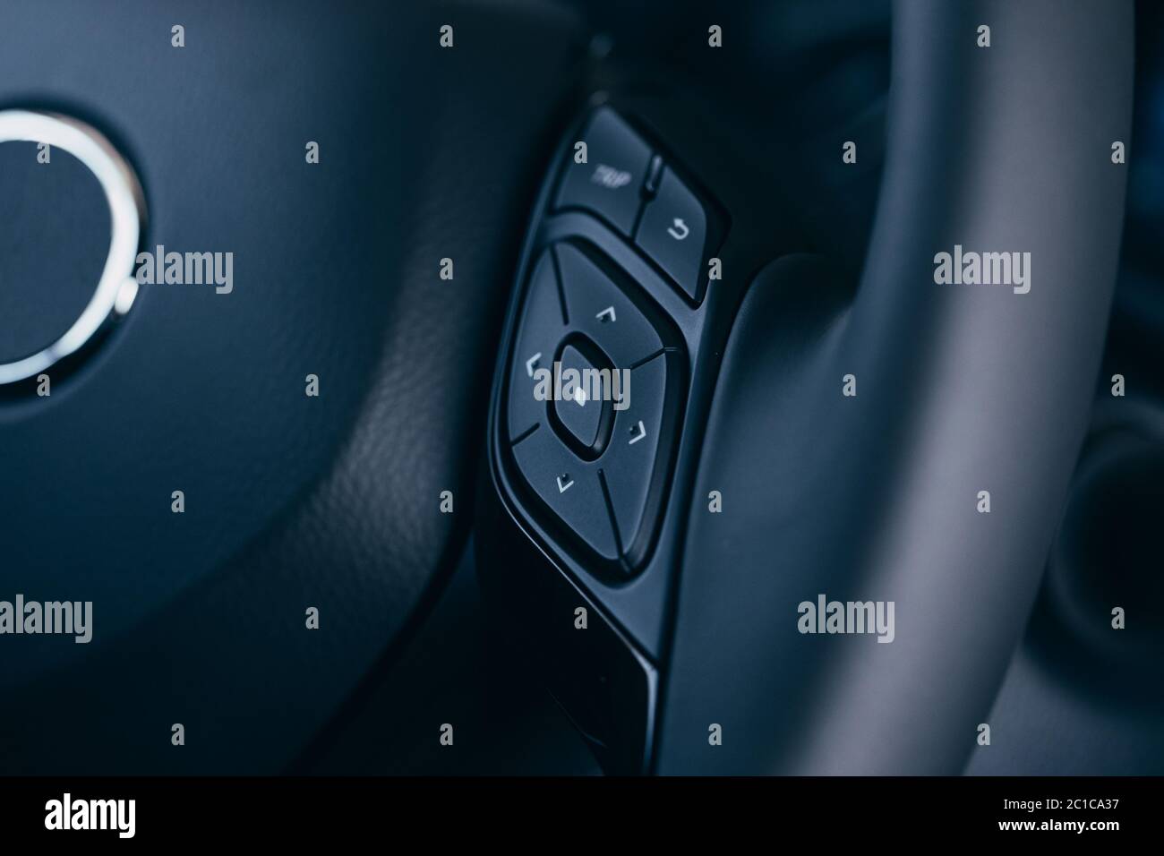 close up Modern black steering wheel with multifunction buttons