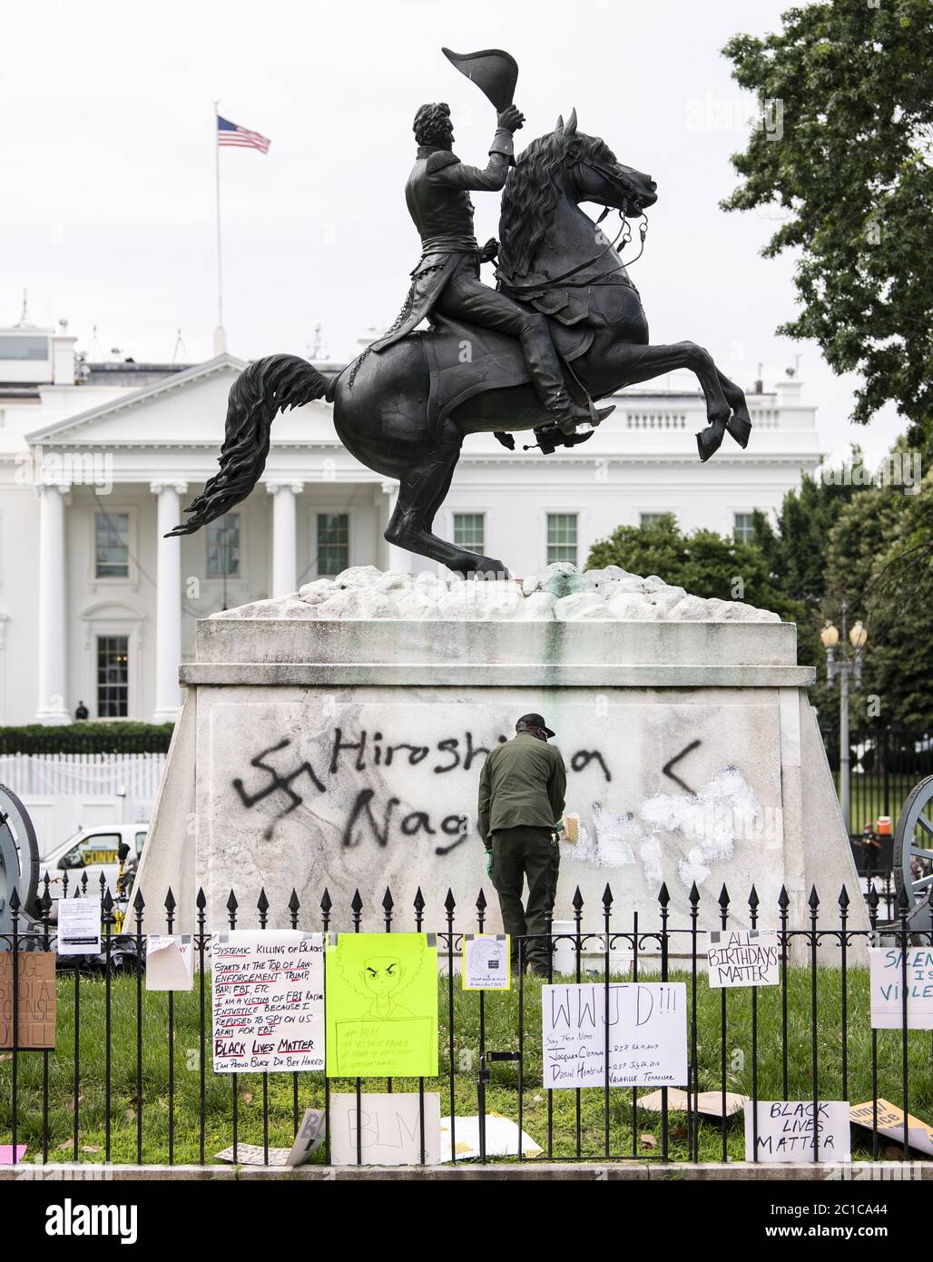 Washington, United States. 15th June, 2020. A member of the Park Service  clean graffiti of a swastika off of the Andrew Jackson in Lafayette Park,  near the White House, in Washington, DC