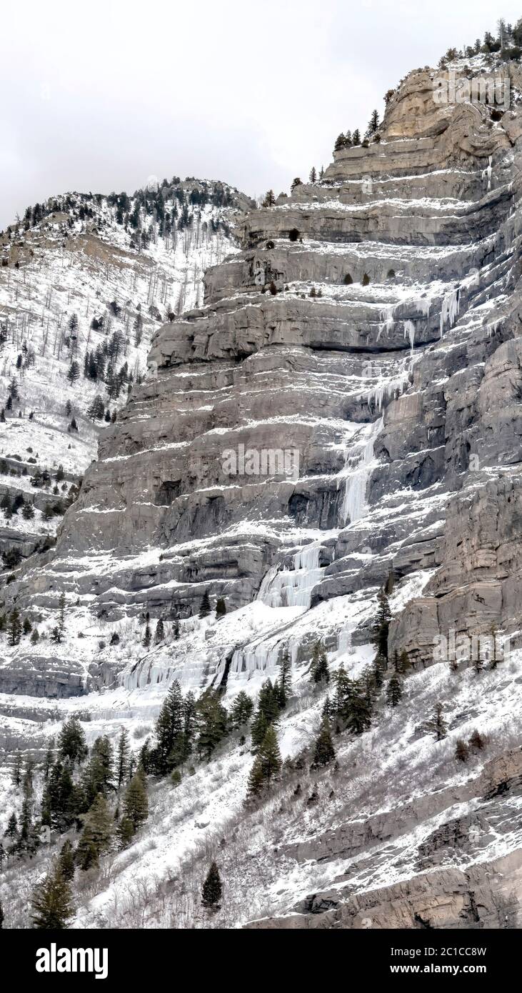 Vertical crop Bridal Veil Falls in Provo Canyon with water on steep