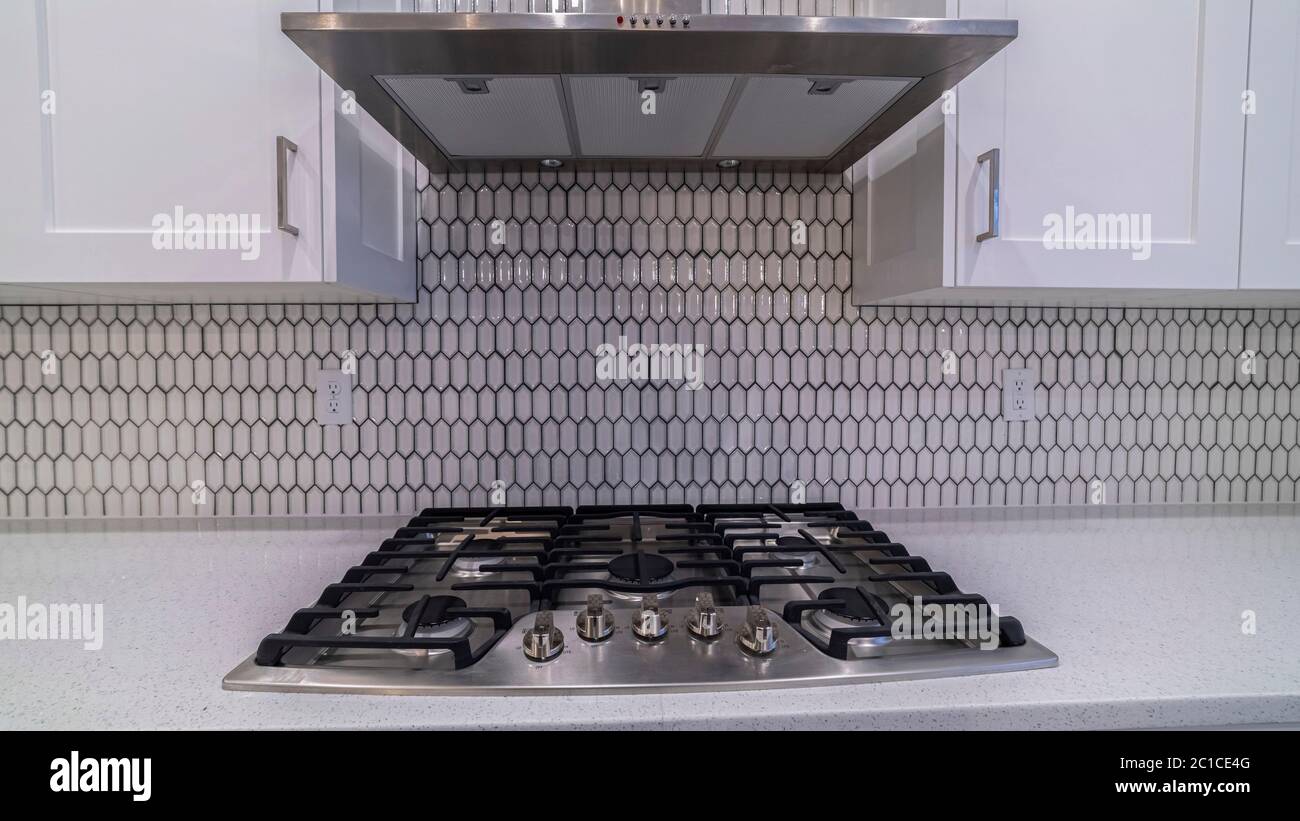 Panorama frame Modern gas cooker hob under an extractor fan Stock Photo