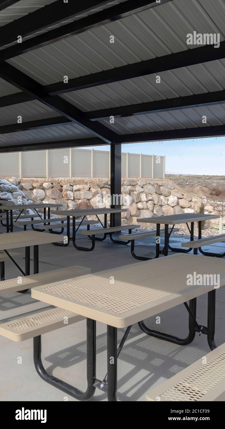 Vertical Tables with seats inside a gabled roof pavilion in South
