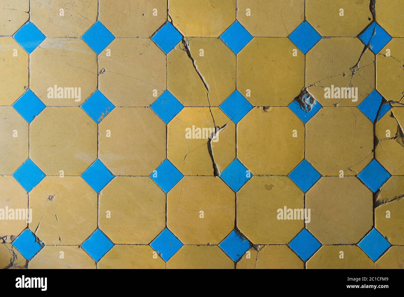 Close-up of an old floor tile with a two-tone pattern. Chapped floor tiles Stock Photo